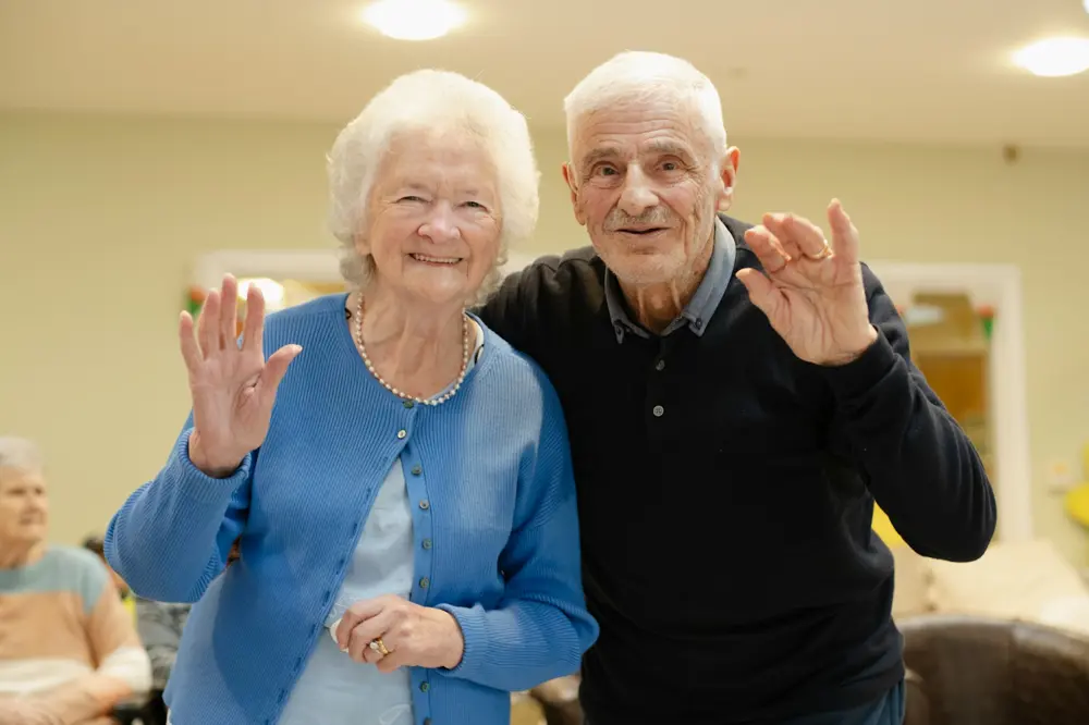 An older couple together in a familiar indoor setting