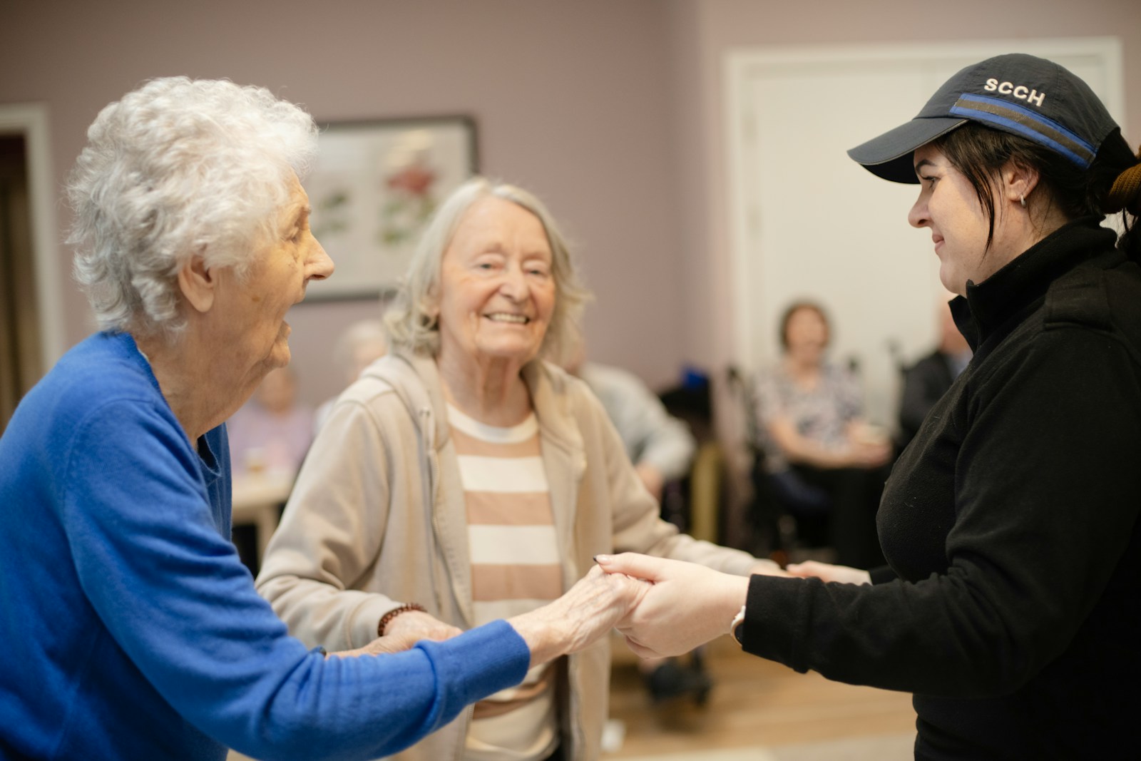 A support worker connecting with two older adults
